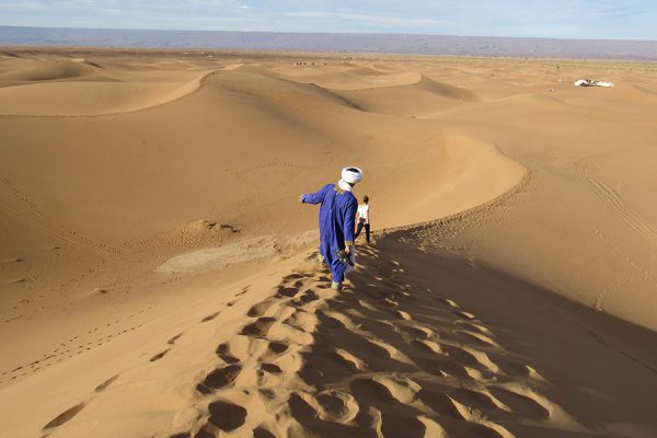 Abdul balances on the dune ridge