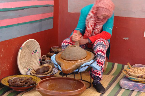 Young woman at argan oil stone mill